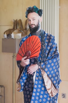 Young man wearing bathrobe night suit posing outdoor.