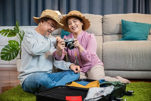 Travel and tourism. Happy mature retired couple photography weekend holiday, Asian couple old senior marry retired couple smiling taking photo by camera during luggage suitcase arranging for travel