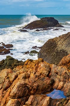 Waves crashing against the rocks in Serra Grande on the coast of the state of Bahia