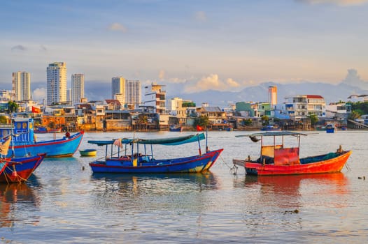There are many traditional Vietnamese fishing boats and vessels in the bay on the river at Vinh Truong Fishing Port in Nha Trang, Vietnam