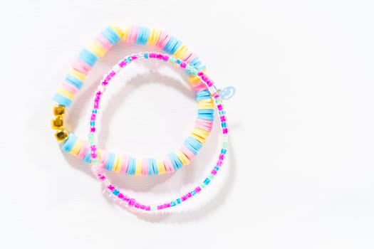 Little girl's charming bracelets adorned with clay and sea beads.