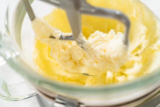 Close-up of a stand mixer creaming together butter and sugar for the Chocolate Ginger Sugar Cookie Dough, creating a light, fluffy base.