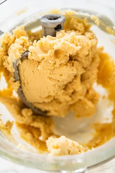 Close-up view of Classic Sugar Cookie Dough in a stand mixer bowl, showcasing the creamy, well-mixed texture of the dough. This step combines butter, sugar, and other ingredients to create a smooth and cohesive dough, ready for chilling or shaping.