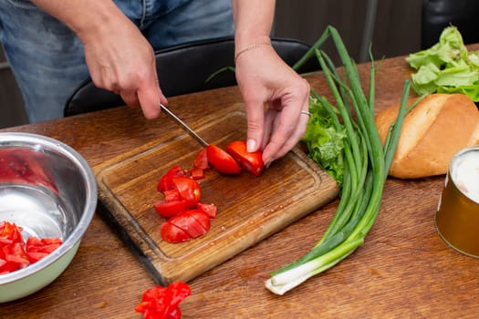 Chop the green onions and tomatoes and place them in a bowl. Prepare the salad.