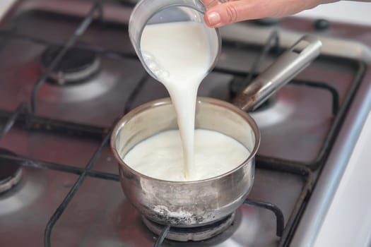 Boil milk in a small saucepan on the stove. Prepare milk porridge.