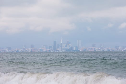 Beautiful breeze from the waves of the sea against the backdrop of the city.