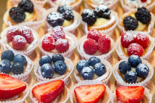 Sweet dessert. Basket cake with raspberries and blueberries.