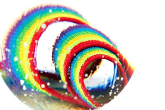 Optical abstract background of rainbow fabric with kinks and light effects in water drops.