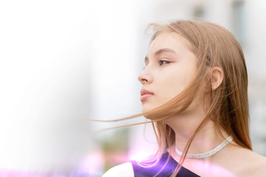 A beautiful woman in profile with flying strands of hair against a bokeh background. Portrait of a young romantic girl.
