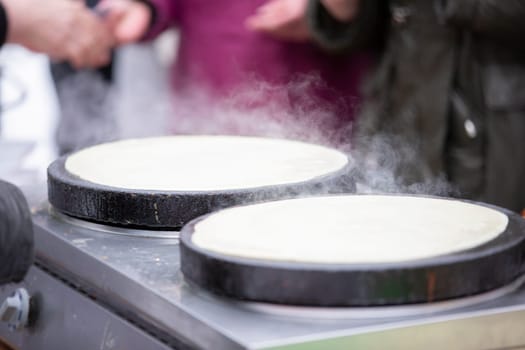 Street food. Fried pancakes in a street cafe.