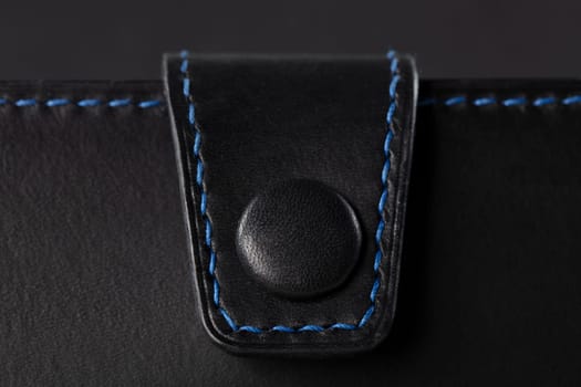 Black leather product closeup on a black background.
