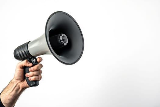 A person holds a handheld megaphone, ready to address a crowd, emphasizing the importance of communication at gatherings.