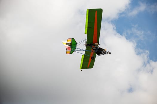 Stunt plane leaves smoke trail in thrilling aerobatic performance against blue sky. Skilled pilot demonstrates acrobatic skills showcasing aerial artistry and precision.