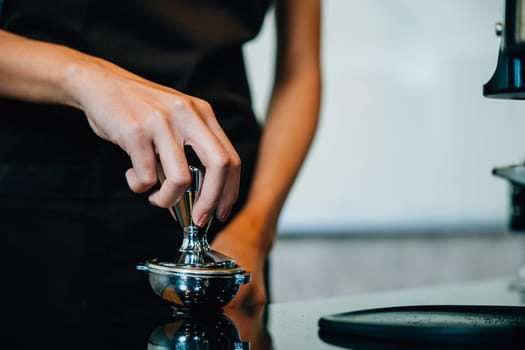 Fresh tasty coffee brewed by coffee machine in cafe or pub. Step by step guide to professional coffee making. Close up of machine hand holding handle pouring espresso.