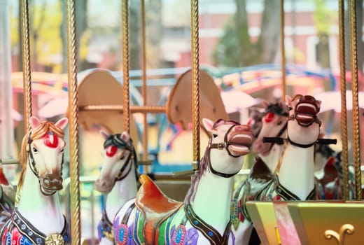Vintage retro carousel horse. Children's attraction in the old park.