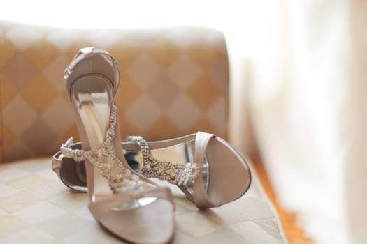 Stylish and highly fashionable woman high heeled shoes with trendy accessories, captured on a colorful background, exuding luxury and elegance perfect for wedding or formal outfit inspiration, good for fashion magazine content