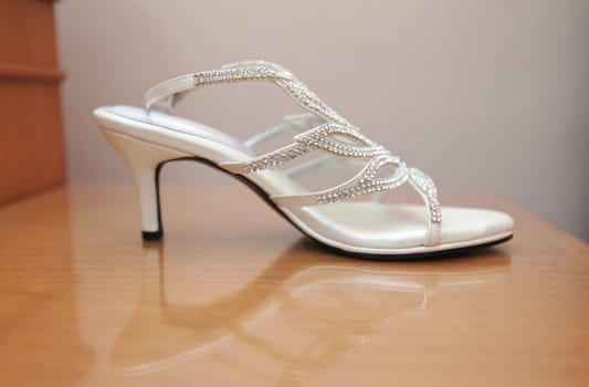 Stylish and highly fashionable woman high heeled shoes with trendy accessories, captured on a colorful background, exuding luxury and elegance perfect for wedding or formal outfit inspiration, good for fashion magazine content