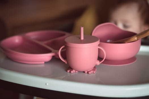 Set of baby dishes made of bpa free silicone. Safe and non-poisonous tableware for kids. Ecologic and recycle concept. High quality photo