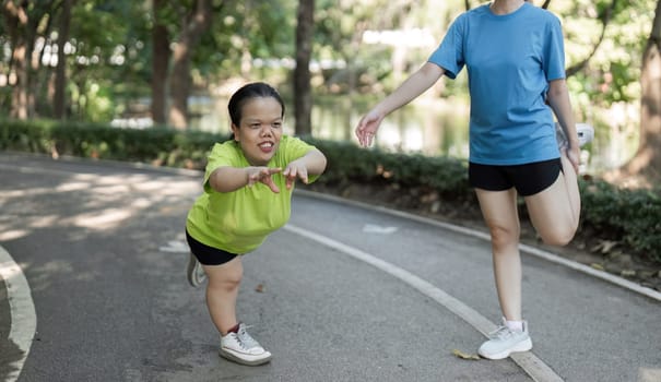 A petite disabled woman enjoys a workout in the park with her friend, highlighting inclusivity and active lifestyles.