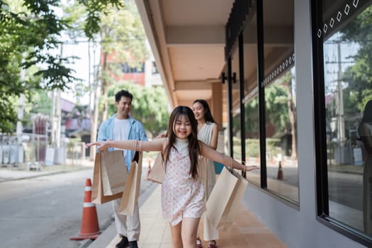 Happy family with parents and children enjoying a shopping day, capturing joyful moments in a modern urban environment.