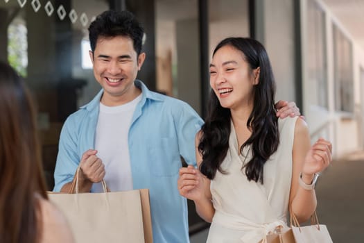 Happy parents and children enjoy a lively holiday shopping trip, sharing laughter and excitement.