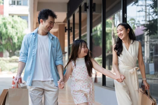 A joyful family with parents and children shopping happily, showcasing modern lifestyle and family bonding.