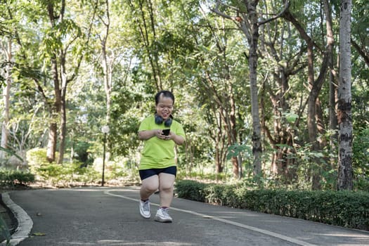 A small disabled young woman jogging on a park path, embracing fitness and empowerment.