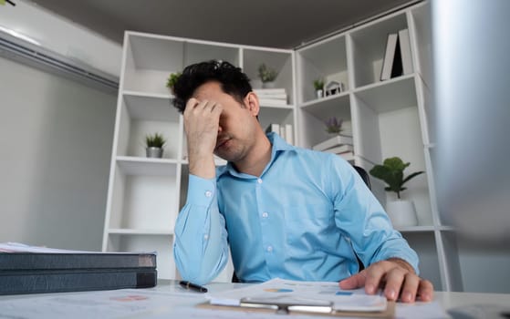 A weary professional reflects on his hard work capturing the essence of fatigue in a office setting.