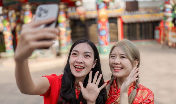 Two friends capture their excitement during Chinese New Year celebrations showcasing joy and vibrant culture.
