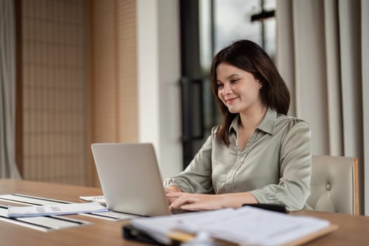 A focused businesswoman engages in remote work exemplifying the professional lifestyle.