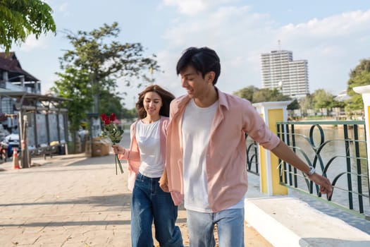 A couple strolls along a riverside celebrating love and connection on Valentine's Day creating lasting memories together.