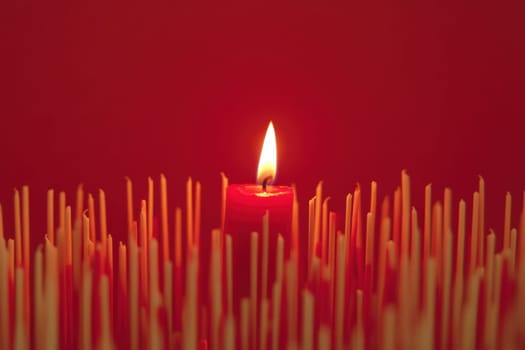 One Red Candle on a festive background. Advent, Christmas, holiday and traditions.