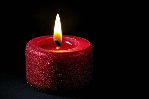 One Red Candle on a festive background. Advent, Christmas, holiday and traditions.