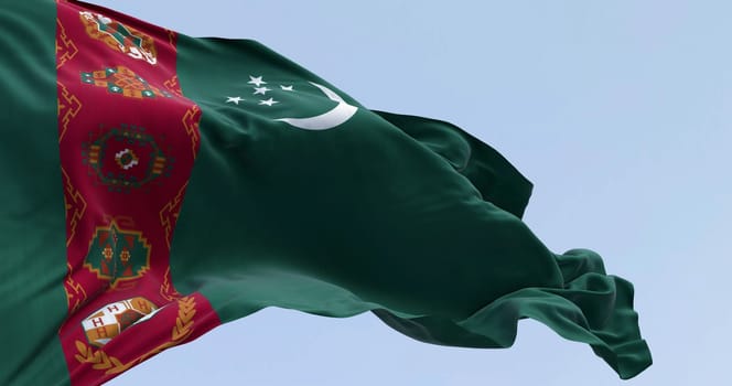 Close-up of Turkmenistan national flag waving. Green field, red vertical band, crescent moon, five stars, carpet motifs. 3d illustration render. Selective focus. Close-up. Textured background