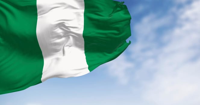Nigeria national flag waving on a clear day. Three equal vertical bands: green, white and green. 3d illustration render. Selective focus. Close-up.