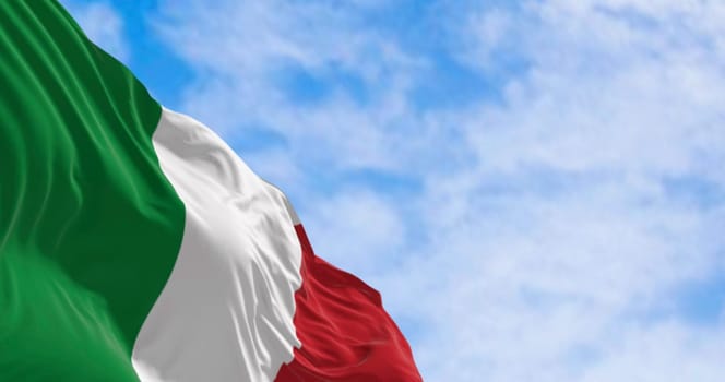Close-up of the national flag of Italy waving in the wind on a clear day. Three vertical bands of green, white and red. 3d illustration render. Rippled fabric