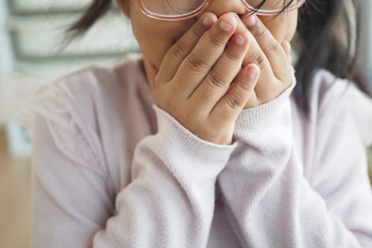 A child in oversized glasses shows various emotions indoors, highlighting their innocence
