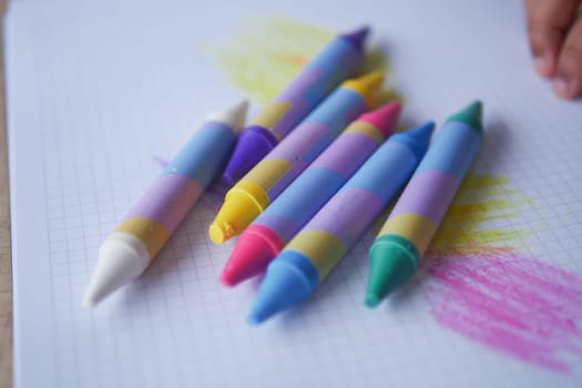 A colorful assortment of crayons is organized on graph paper, ready for your creative fun