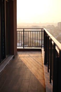 Imagine a peaceful balcony adorned with furnishings, offering a breathtaking sunset view