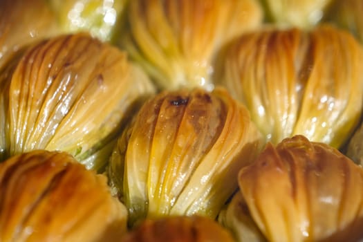 Enjoy authentic baklava slices that are beautifully drizzled with stunning pistachio crumbs