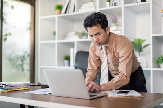 A dedicated business professional engages with laptop in a modern office showcasing productivity and tech-savvy workspace.