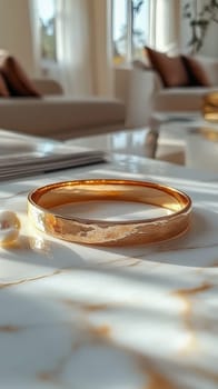 A stunning golden bangle bracelet resting on a marble surface in soft natural light, showcasing luxury and sophistication. Space for text