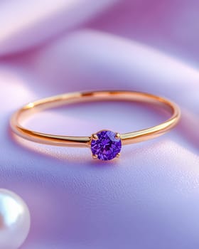 A close-up of an elegant gold ring featuring a sparkling purple gemstone, set on a soft lavender surface, representing luxury and sophistication. Space for text