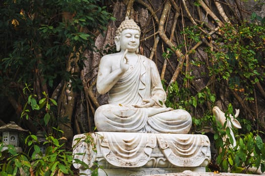 Buddha sculpture in the garden at the pagoda in the marble mountains of Da Nang