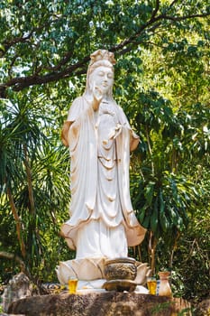 Buddha sculpture in the garden at the pagoda in the marble mountains of Da Nang