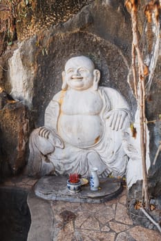 Buddha sculpture in the garden at the pagoda in the marble mountains of Da Nang
