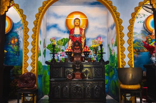 An altar with a Buddha in a pagoda on the marble mountains of Da Nang