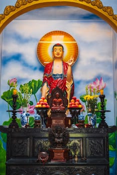 An altar with a Buddha in a pagoda on the marble mountains of Da Nang