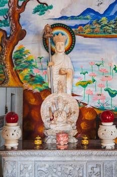An altar with a Buddha inside a temple on the Marble Mountains in Da Nang, Vietnam.