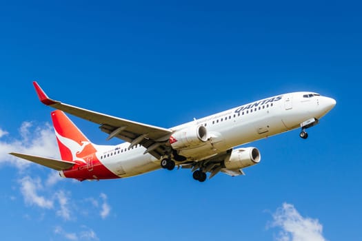 MELBOURNE, AUSTRALIA - SEPTEMBER 07, 2024: A Qantas Boeing 737-838 flies into Melbourne on September 7th 2024